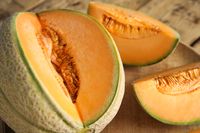 tasty-fresh-cut-melons-on-wooden-tray-closeup-2026-01-06-14-58-24-utc